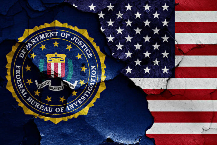 FBI seal superimposed on cracked American flag.