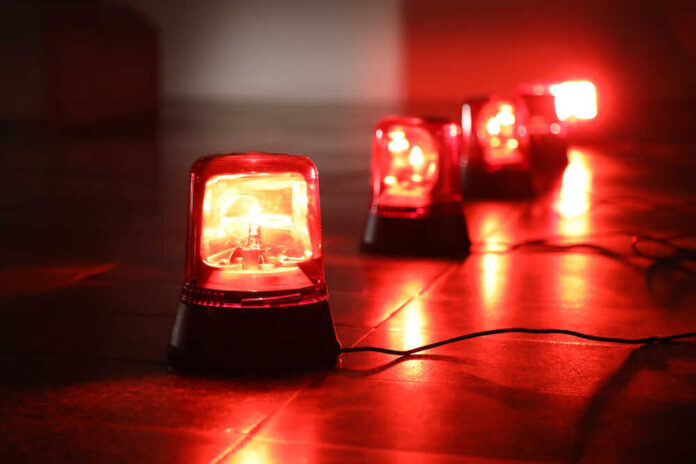 Red emergency lights on dark floor, illuminating the area.