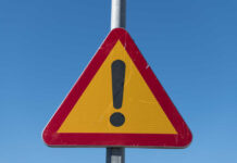 Triangular warning sign with exclamation mark.