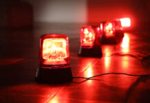 Red emergency lights on a dark floor