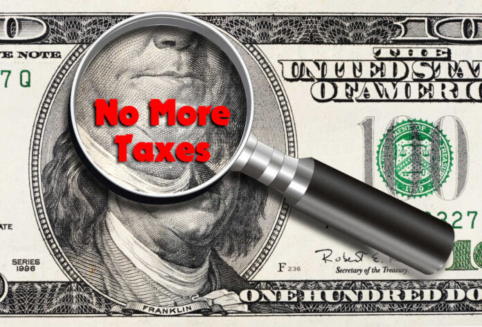 shutterstock_1331612588.jpg featured image Magnifying glass over hundred dollar bill no taxes