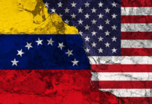 Cracked Venezuela and USA flags side by side