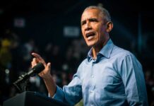 Barack Obama speaks at podium.