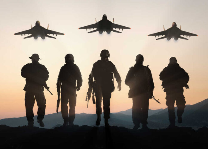 shutterstock_400783420.jpg featured image Silhouettes of soldiers and jets at sunset.