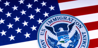 US Immigration and Customs Enforcement badge on flag