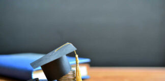 Graduation cap on top of coins to represent student loans