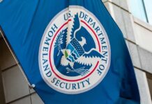 U.S. Department of Homeland Security flag on building.