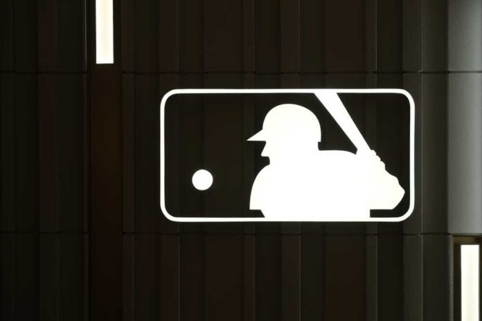 shutterstock_2271619161.jpg featured image MLB logo with a baseball player silhouette