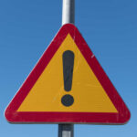 Triangular warning sign with exclamation mark.