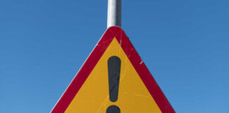 Triangular warning sign with exclamation mark.