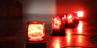 Red emergency lights on dark floor illuminating the area