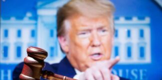 Judge's gavel, Donald Trump speaking in background.