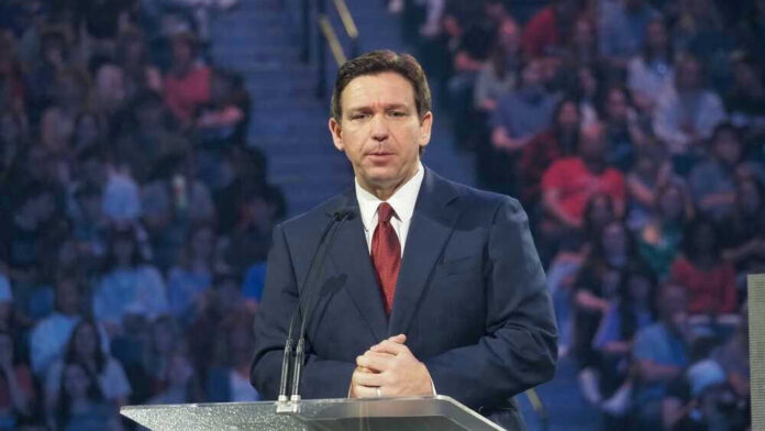 Ron DeSantis in a suit speaking