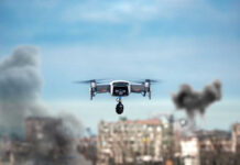 Drone flying over urban area with smoke plumes