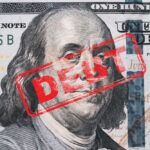 Musk Calls Trump’s Tax Bill ‘DEBT SLAVERY’ Hundred dollar bill with red debt stamp