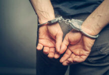 Person with handcuffs behind their back
