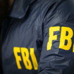 FBI Makes Big Announcement FBI agent in navy blue jacket.