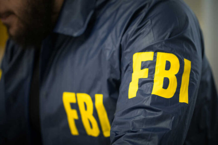 FBI agent in navy blue jacket.