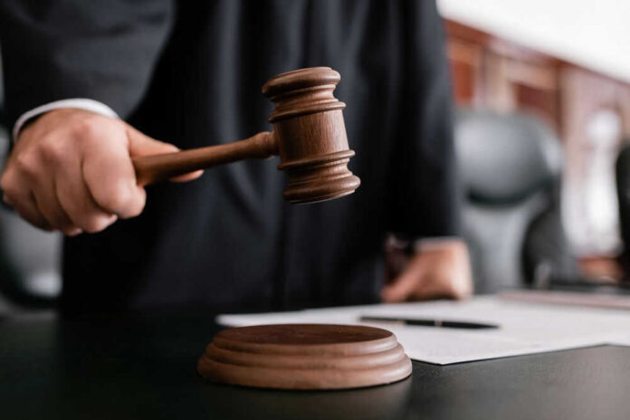 Judge holding gavel in courtroom