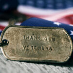 Dog tag and American flag honoring veterans