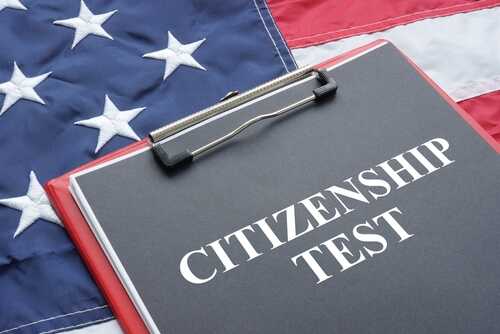 Clipboard with CITIZENSHIP TEST text on an American flag background