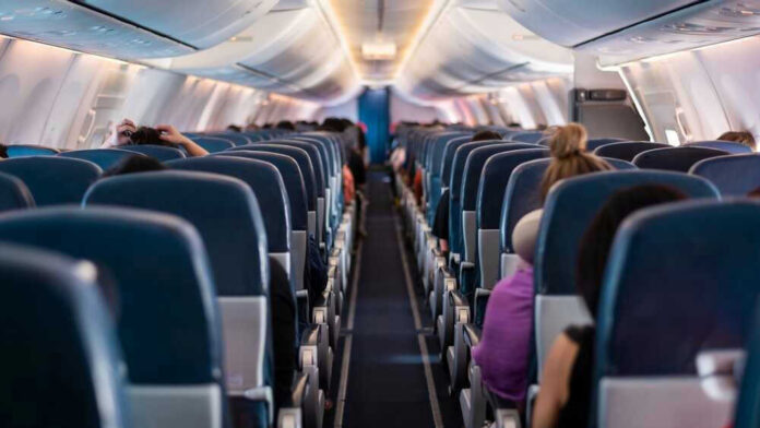 Airplane interior with passengers seated midflight