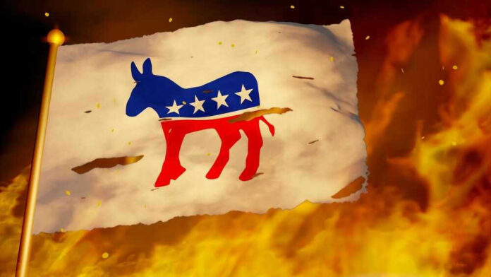 Torn Democrat flag burning amid flames and embers