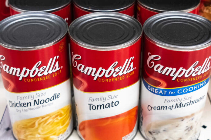 Cans of Campbell's condensed soup on a store shelf