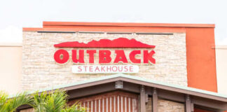 Exterior view of an Outback Steakhouse restaurant with a prominent sign
