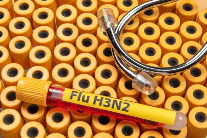 Blood sample labeled for Flu H3N2 on a background of yellow caps