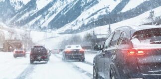 Cars driving on a snowy road in winter conditions