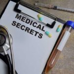 Medical documents with a stethoscope, pills, and a test tube