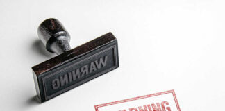 Rubber stamp with warning text imprint