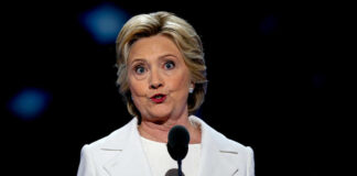 A female politician delivering a speech at a podium