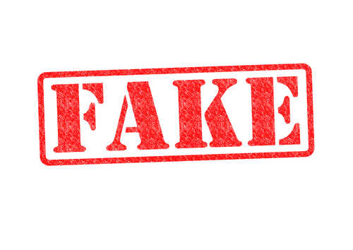 Red stamp with the word FAKE prominently displayed