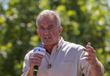Robert F. Kennedy Jr. speaking outdoors with microphone.
