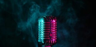 A vintage microphone surrounded by colorful smoke