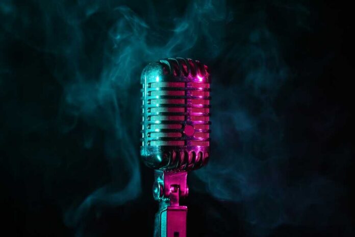 shutterstock_2444207299.jpg A vintage microphone surrounded by colorful smoke