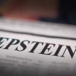 Close-up of a newspaper headline reading 'EPSTEIN'