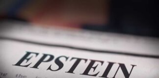 Close-up of a newspaper headline reading 'EPSTEIN'