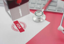 FDA warning stamp near stethoscope and keyboard