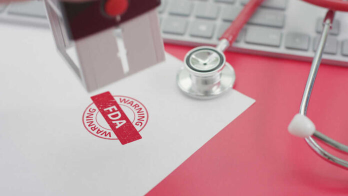 FDA warning stamp near stethoscope and keyboard