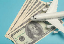 A model airplane placed on top of dollar bills