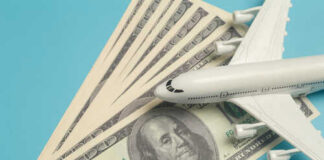 A model airplane placed on top of dollar bills