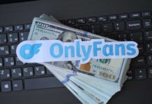 OnlyFans logo placed on a stack of hundred dollar bills