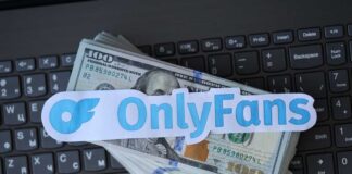 OnlyFans logo placed on a stack of hundred dollar bills