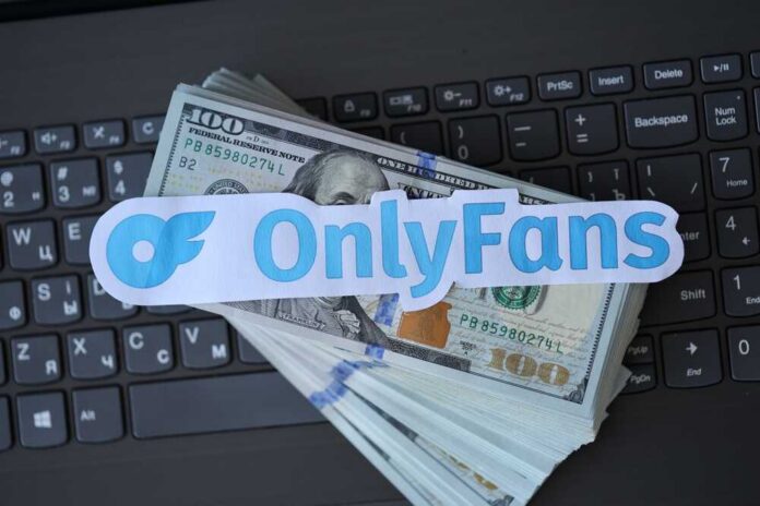OnlyFans logo placed on a stack of hundred dollar bills