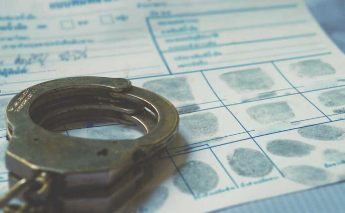 Handcuffs on a fingerprint document.