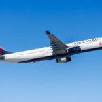 Air Canada airplane flying against a clear blue sky