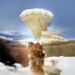 A large mushroom cloud rising into the sky from a nuclear explosion